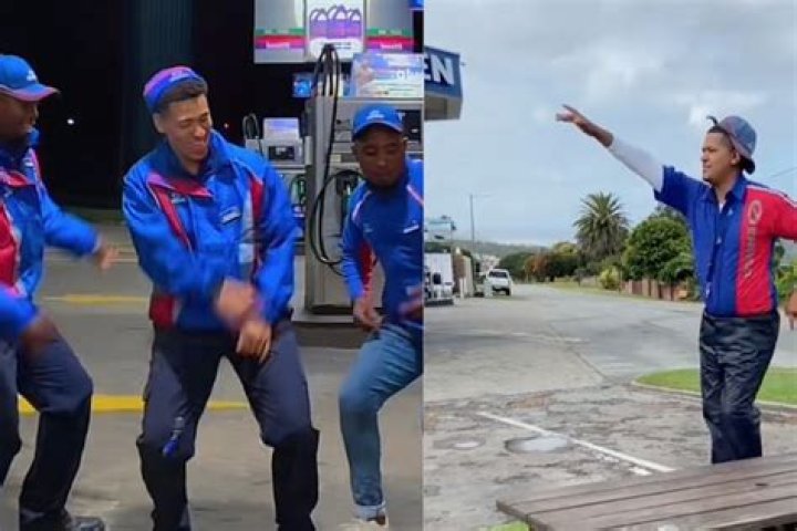 A BP petrol attendant dances with a woman A BP petrol attendant dances with a woman