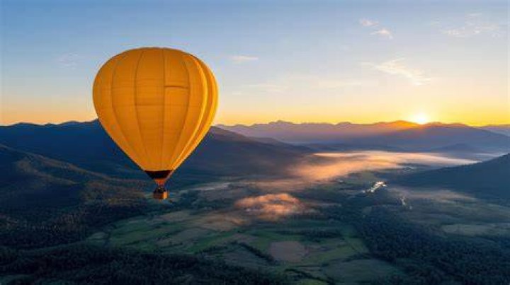A large balloon drifts above the Kingstown, N.C. area, with an airplane and its contrail seen below it. Photo / Brian Branch via AP