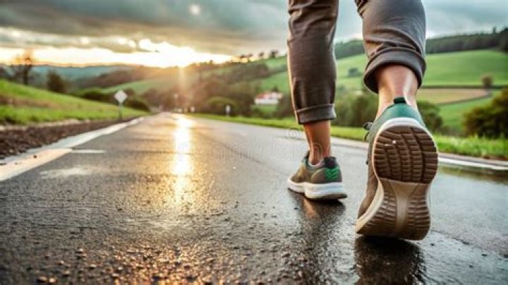 A pair of legs walking towards a house in the poster for X