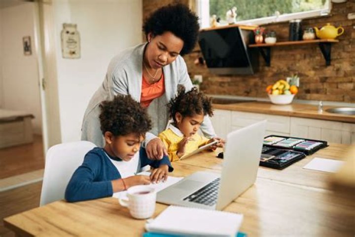 A parent homeschooling his kid A parent homeschooling his kid