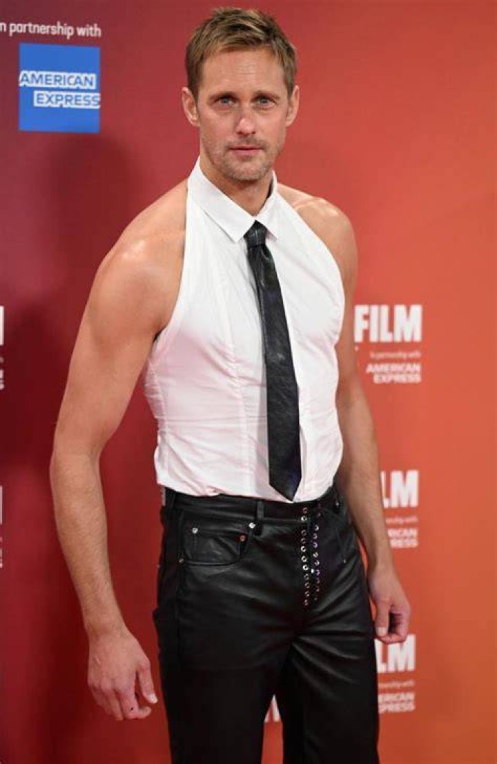 Actor Alexander Skarsgard wearing a wolf's head headdress in the movie The Northman