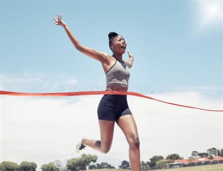 African American woman running hands through long natural hair braids
