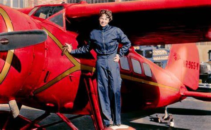 Amelia Earhart beside the red and gold monoplane which she brought down to become the first women to ever complete a solo flight across the Atlantic, May 21, 1932. Photo / AP