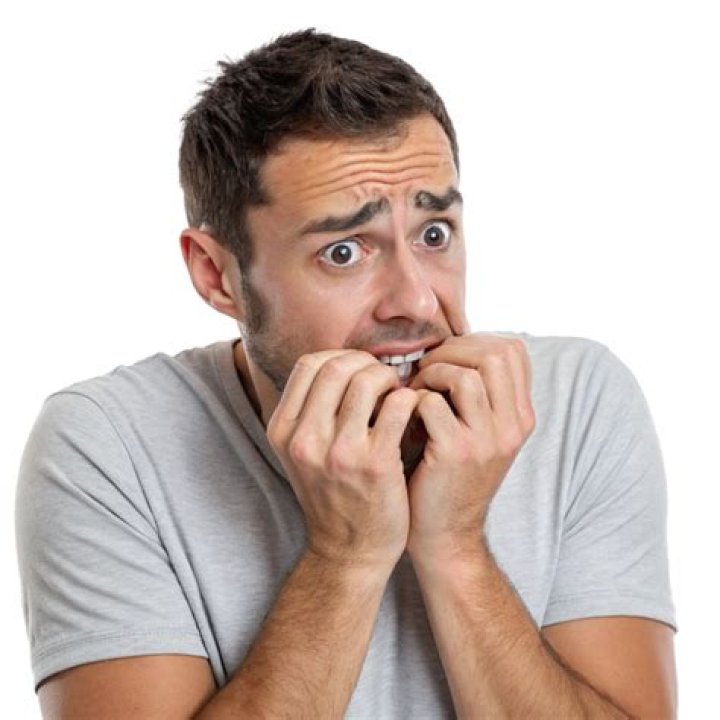 An image of Deok-su nervously sweating as he looks at Mi-nyeo in Squid Game.