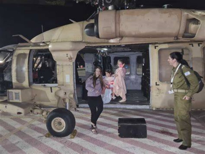 Aviv Asher, 2, her sister Raz Asher, 4, and mother Doron, react as they meet with Yoni, Doron's husband and their father, after they returned to Israel at the Schneider Children's Medical Centre. Photo / Schneider Children’s Medical Centre via AP