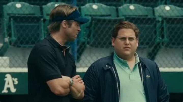 Brad Pitt and Jonah Hill on a baseball field in Moneyball