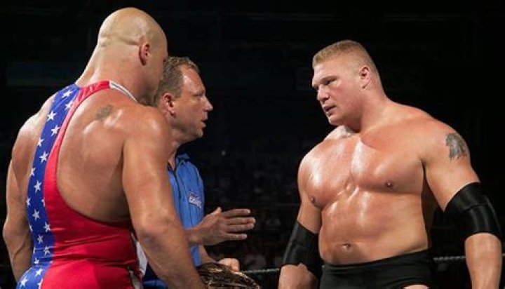 Brock Lesnar with Kurt Angle on shoulders in ring