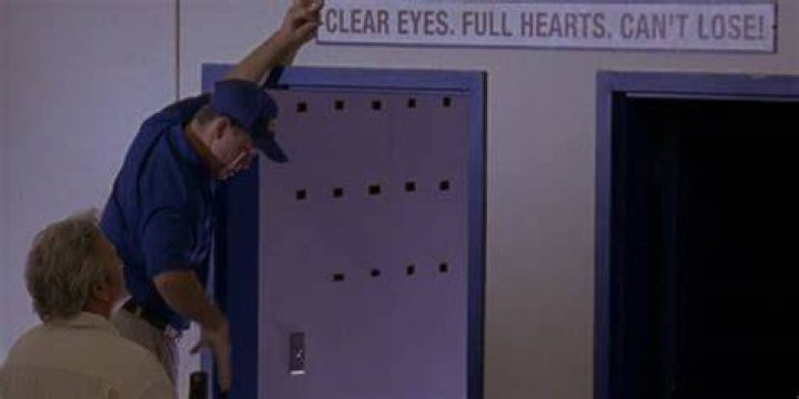 Buddy Garrity hangs a sign reading 