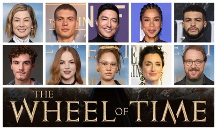 Cast members of Wheel of Time stand together with Lord of the Rings posters in the background 
