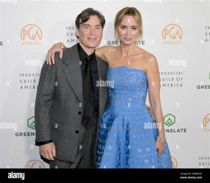 Cillian Murphy and Emily Blunt touch hands in Oppenheimer