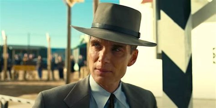 Cillian Murphy as Oppenheimer turning to face someone in Oppenheimer