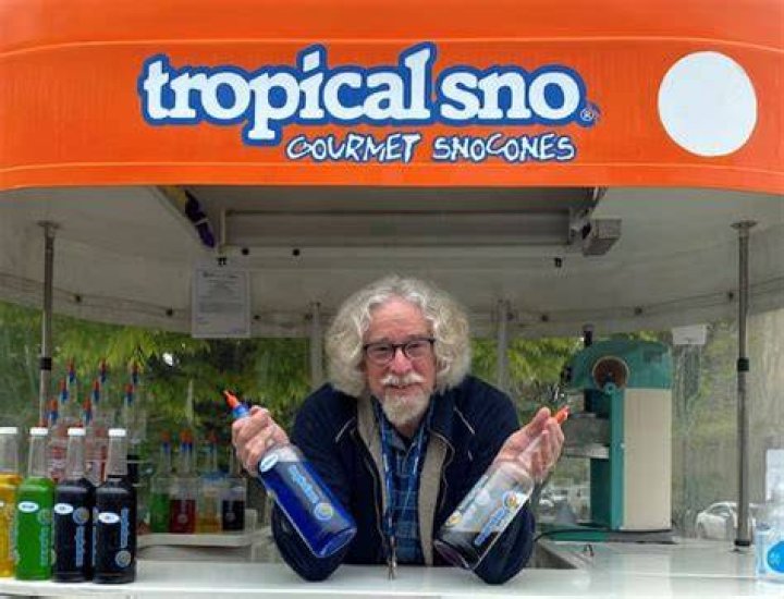 Dave Mitchell selling his flavoured shave ice from his orange-topped caravan in Canberra. Photo / Joanna Wane