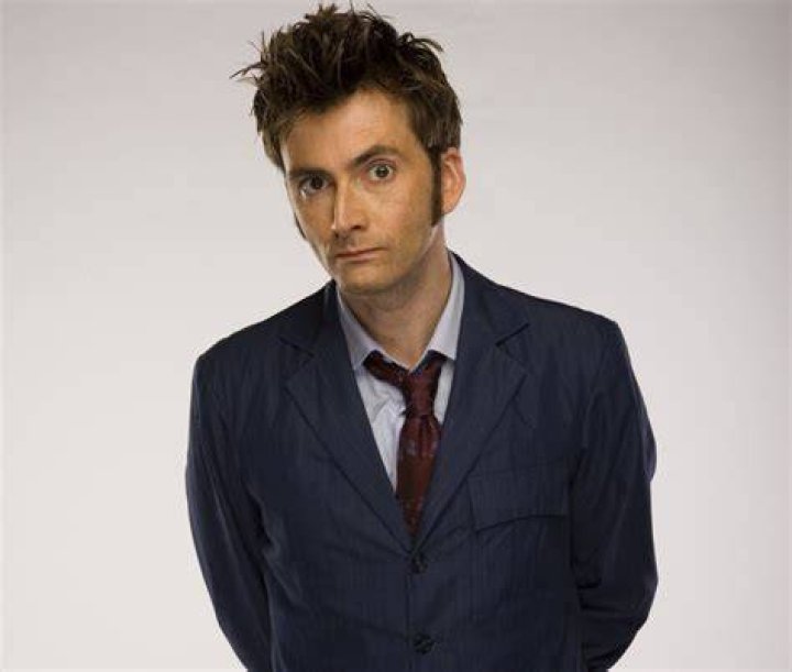 David Tennant smiles as the TARDIS flies through the vortex behind him
