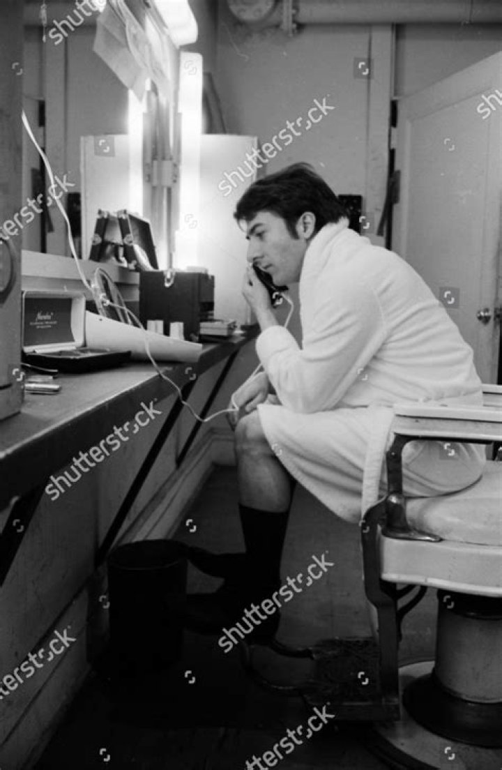 Dustin Hoffman sitting in front of a fish tank in The Graduate