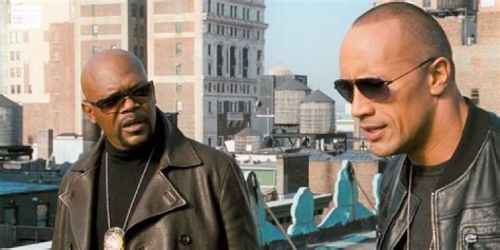 Dwayne Johnson and Samuel L Jackson on a rooftop just before they jump 