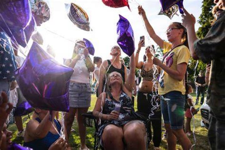 Family and friends hold candles during a vigil for Harris Wolobah. Photo / AP