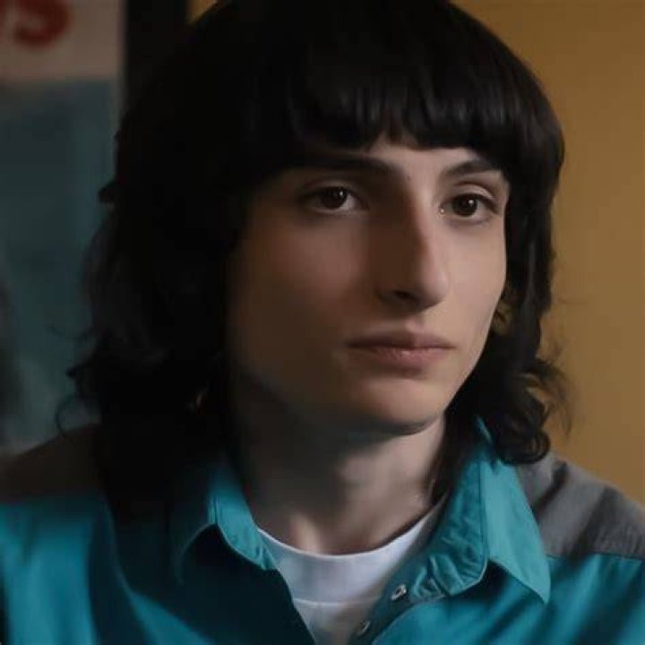 Finn Wolfhard as Mike Wheeler, Maya Hawke as Robin Buckley, and Caleb McLaughlin as Lucas Sinclair in Stranger Things season 4.