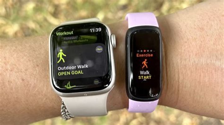 Fitbit Inspire 2 next to an iPhone with the Fitbit app