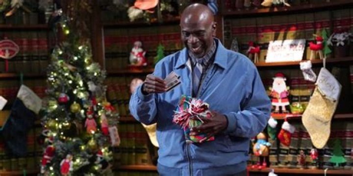 Flobert opens a Christmas present in Night Court
