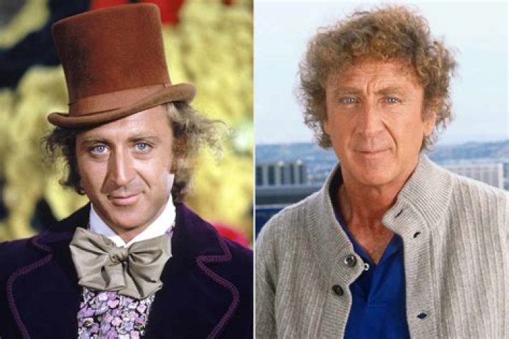Gene Wilder as Willy Wonka standing on a boat with windows behind him in Willy Wonka and the Chocolate Factory.