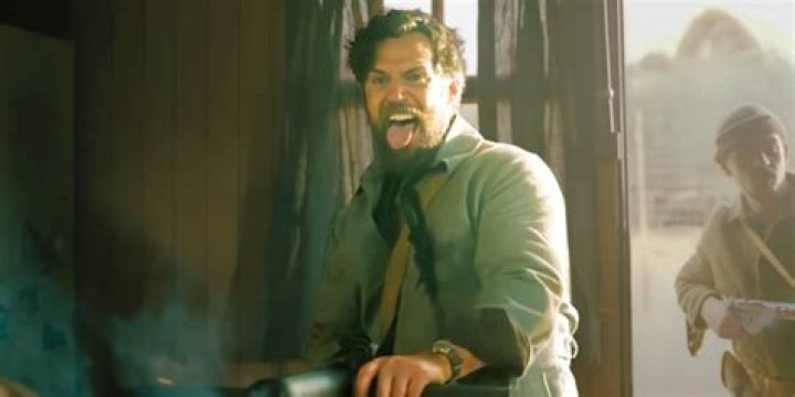 Henry Cavill shooting a gun in The Ministry of Ungentlemanly Warfare juxtaposted with Cavill in The Man From UNCLE.