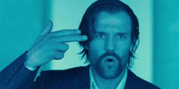 Jason Statham with his fingers to his head in Revolver