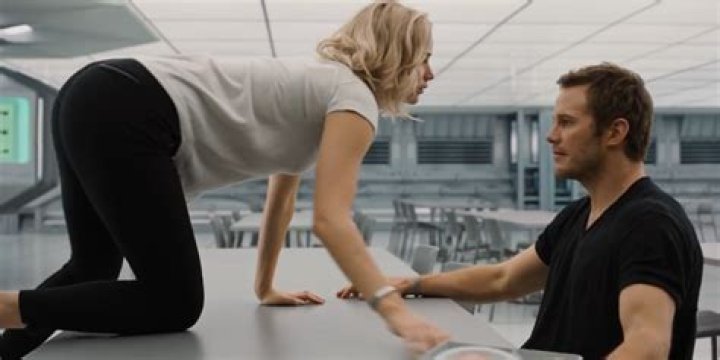 Jennifer Lawrence crawls over a table to Chris Pratt in Passengers