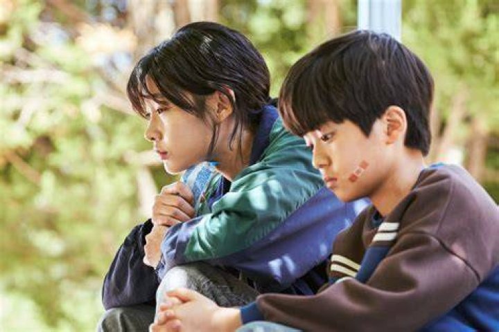 Ji-yeong looking at Sae-byeok in Squid Game.