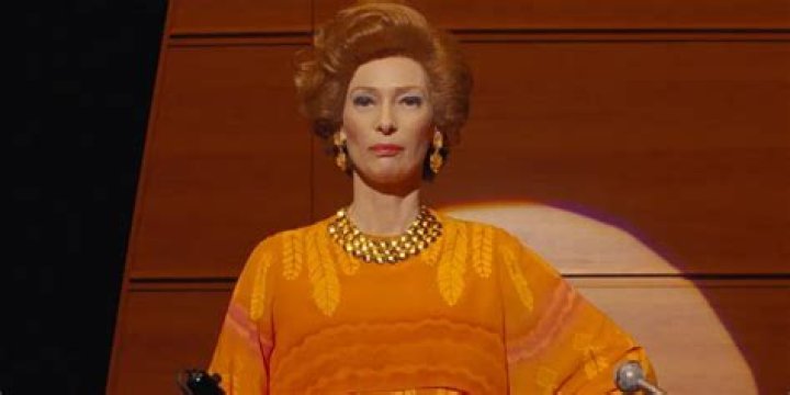 JKL Berenson wears orange dress in The French Dispatch
