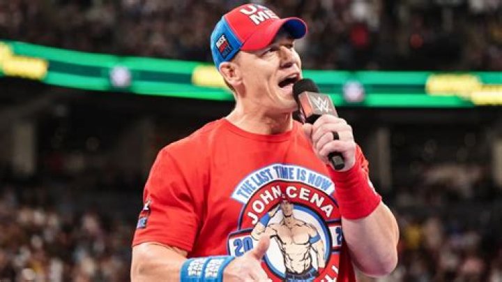 John Cena with cast of Manhunt and walking to ring with arms out