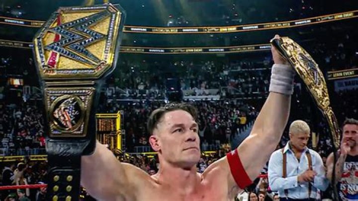 John Cena working out and looking down at wrist tape