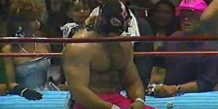 Konnan preparing to unmask.