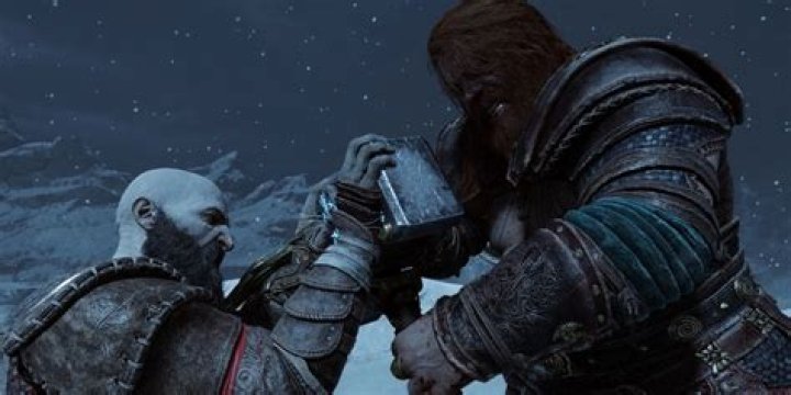 Kratos holding a shield and fighting an enemy