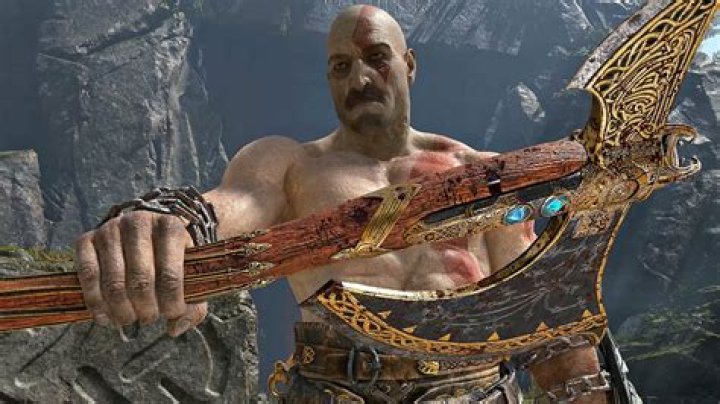 Kratos wielding an axe and talking to a fallen enemy