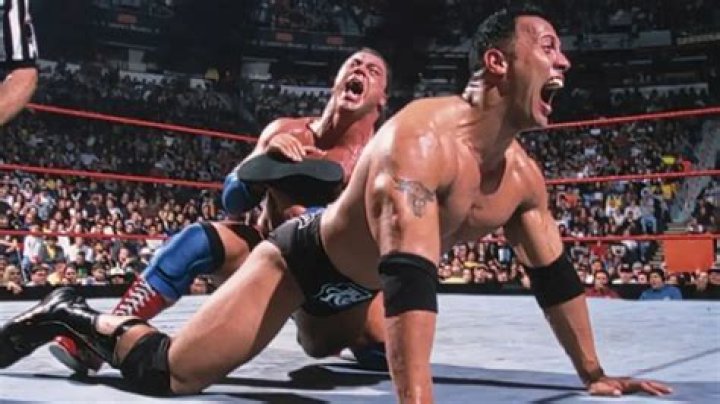 Kurt Angle and The Rock celebrate winning the top belts in the Invasion timeline