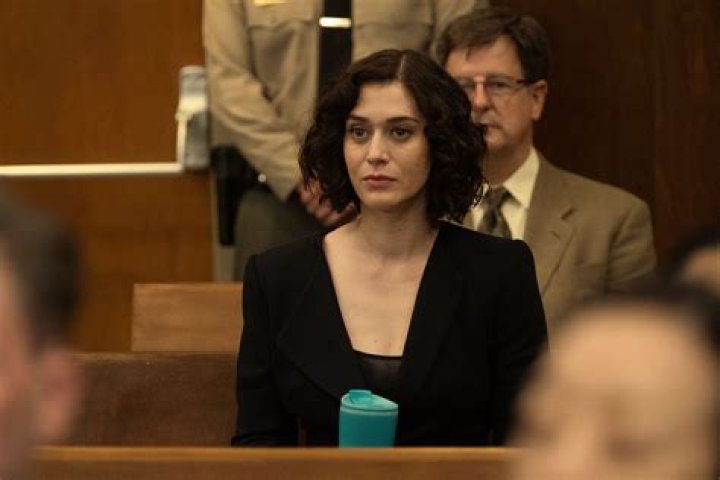 Lizzy Caplan as Alex Forrest smiling in Fatal Attraction.