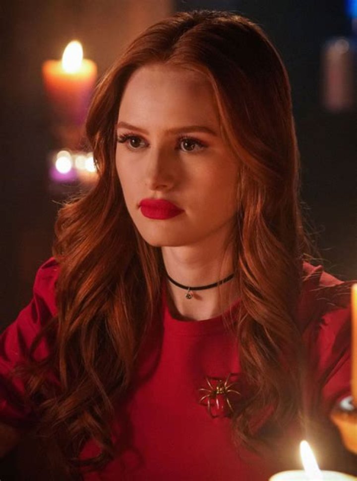 Madelaine Petsch as Cheryl Blossom and KJ Apa as Archie Andrews sitting in class in Riverdale season 7