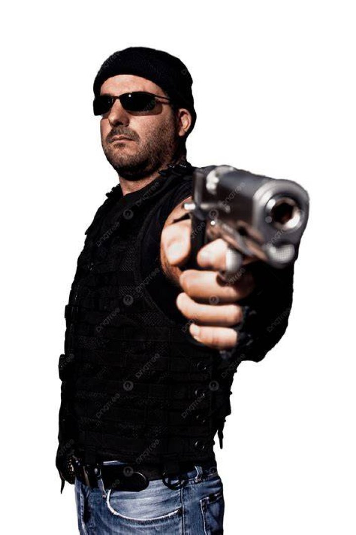 Mason pointing a gun at someone in Hard to Kill.