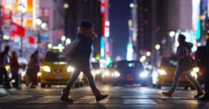 Mei walking down the street smiling in Turning Red