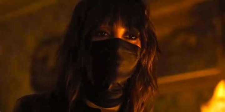 Melissa Barrera wearing a black mask over her lower face in Abigail