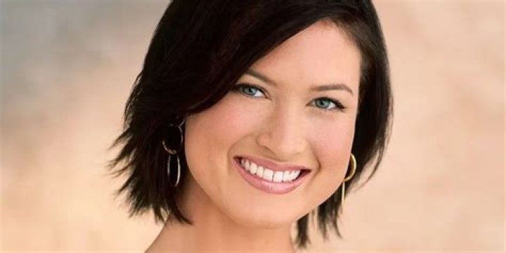 Meredith Phillips The Bachelorette smiling in front of beige background