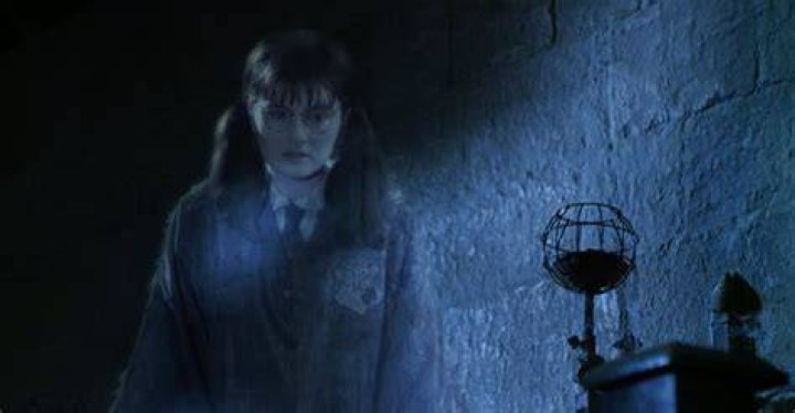 Moaning Myrtle in Harry Potter smiles mischieviously.