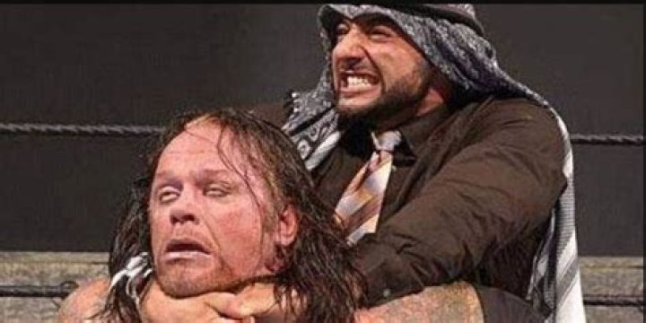Muhammad Hassan applies the Camel Clutch to The Undertaker