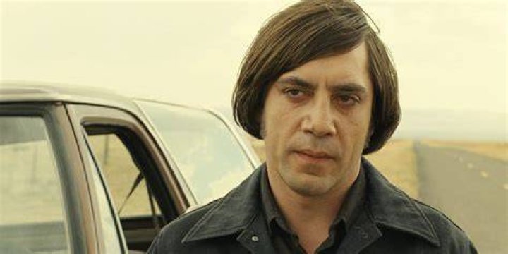 No Country for Old Men 2007 Llewlyn Moss standing by the river holding his pistol out