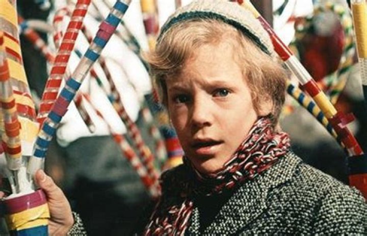 Peter Ostrum as Charlie Bucket holding up a Golden Ticket in Willy Wonka & The Chocolate Factory