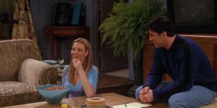 Phoebe and Joey sitting in Monica's living room in Friends