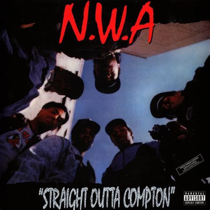 Rap group NWA from Straight Out of Compton walking by trucks