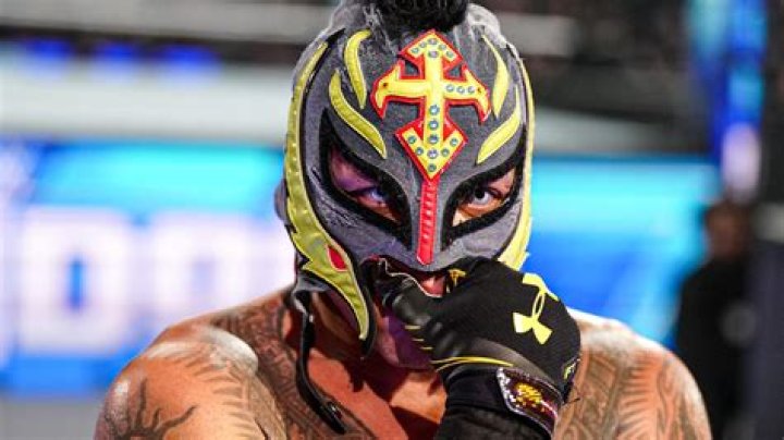 Rey Mysterio being unmasked by Konnan.