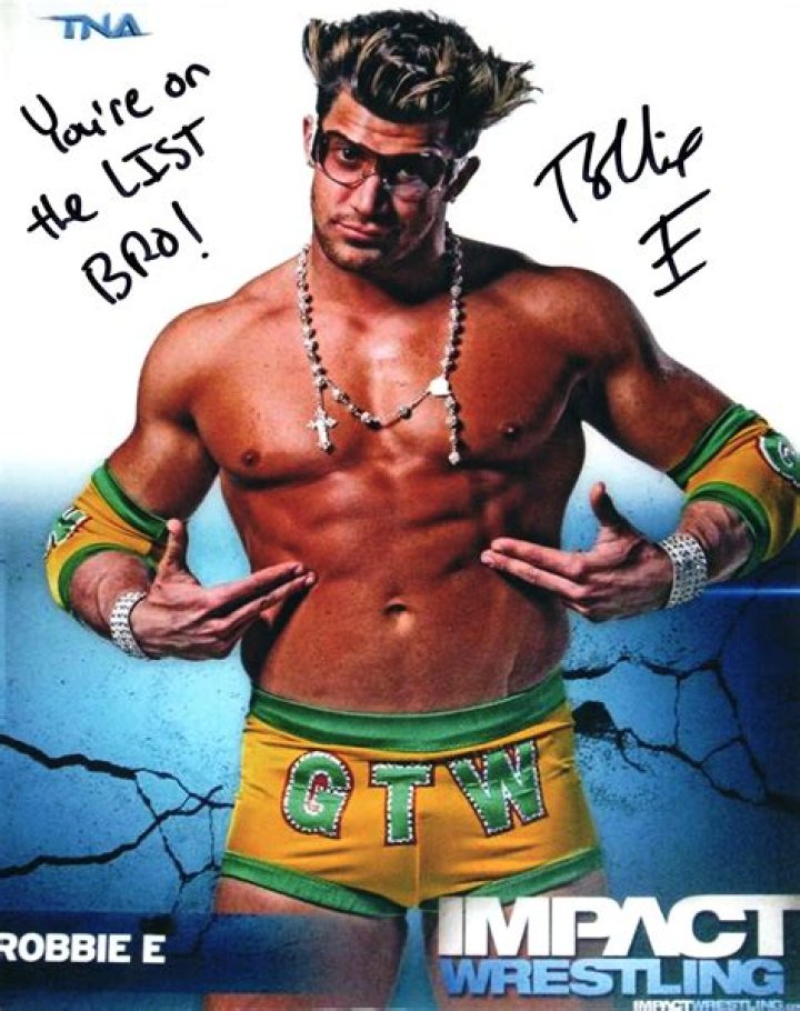Robbie E in TNA with X Division belt and in NXT with mic and suit as manager