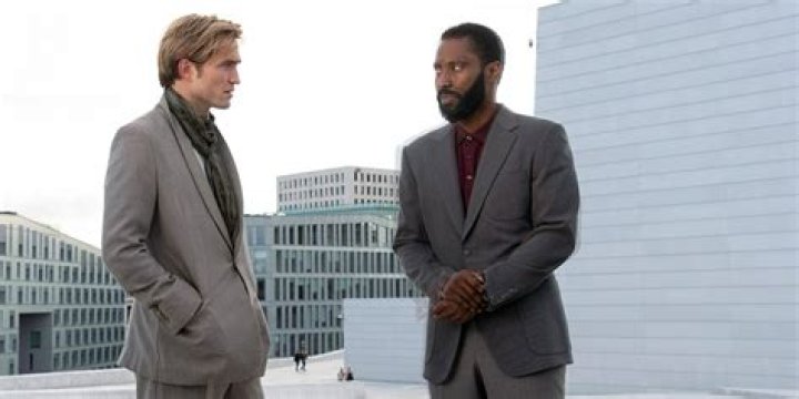 Robert Pattinson as Neil and John David Washington as the Protagonist Speaking to Each Other in Tenet